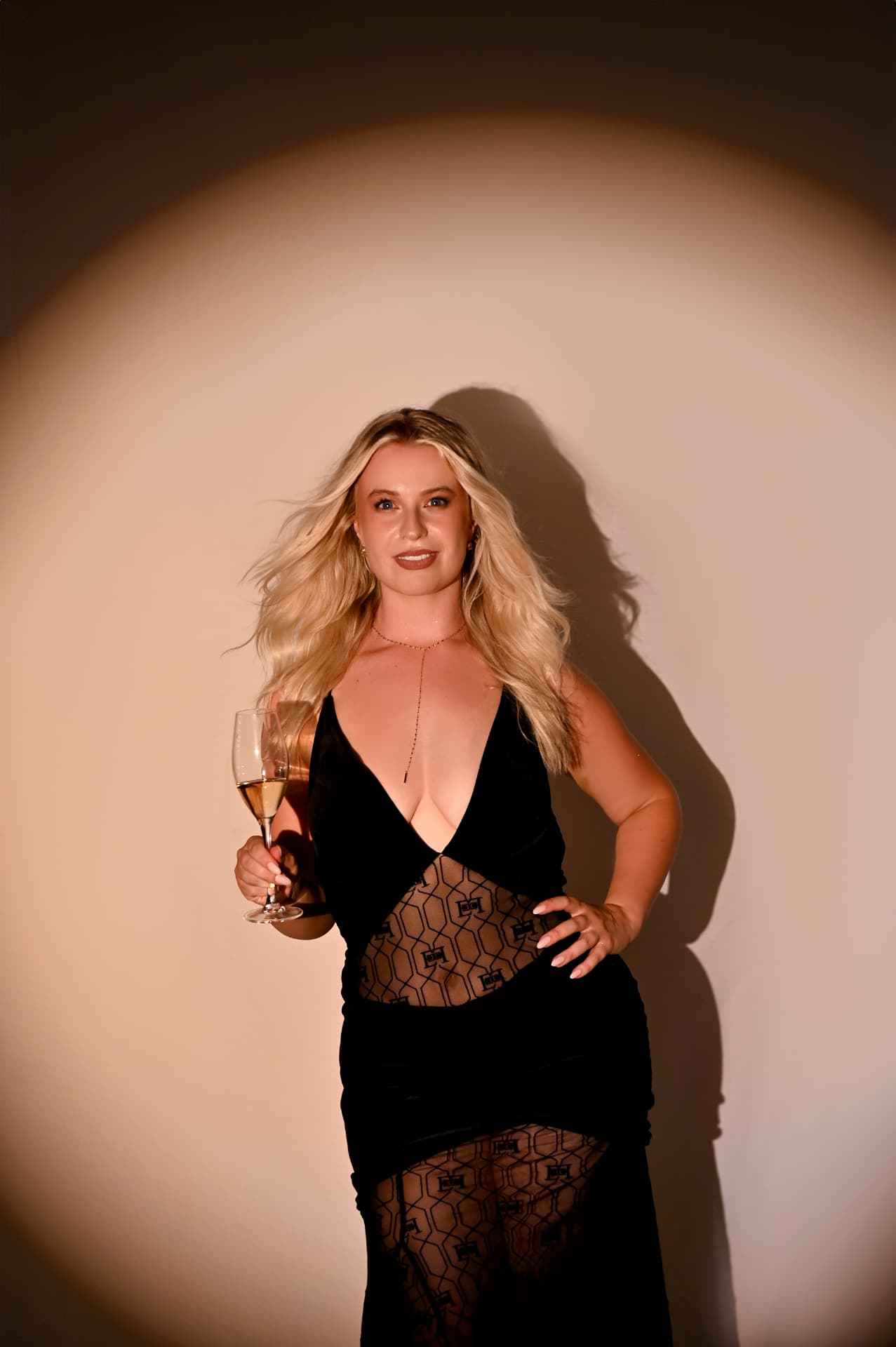 One of the sisters celebrating with a glass in hand